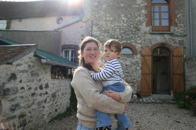 France, a village in the Champaign region - Christine, wife of Lawerence, and her son outside their beautifully remodeled hundre