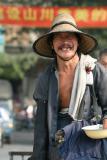 China, Guangdong, Gaozhou city - A kindly begger stops to pose for a photo (Peter