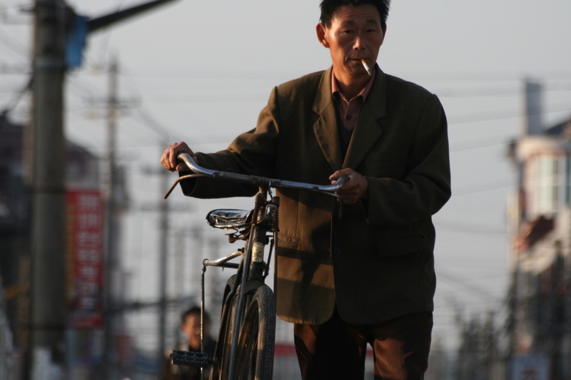 Oct 9 2007 - Changrong village, Jiangsu Prov, China. Morning on the street. Smoking seems almost mandatory for Chinese men, its 