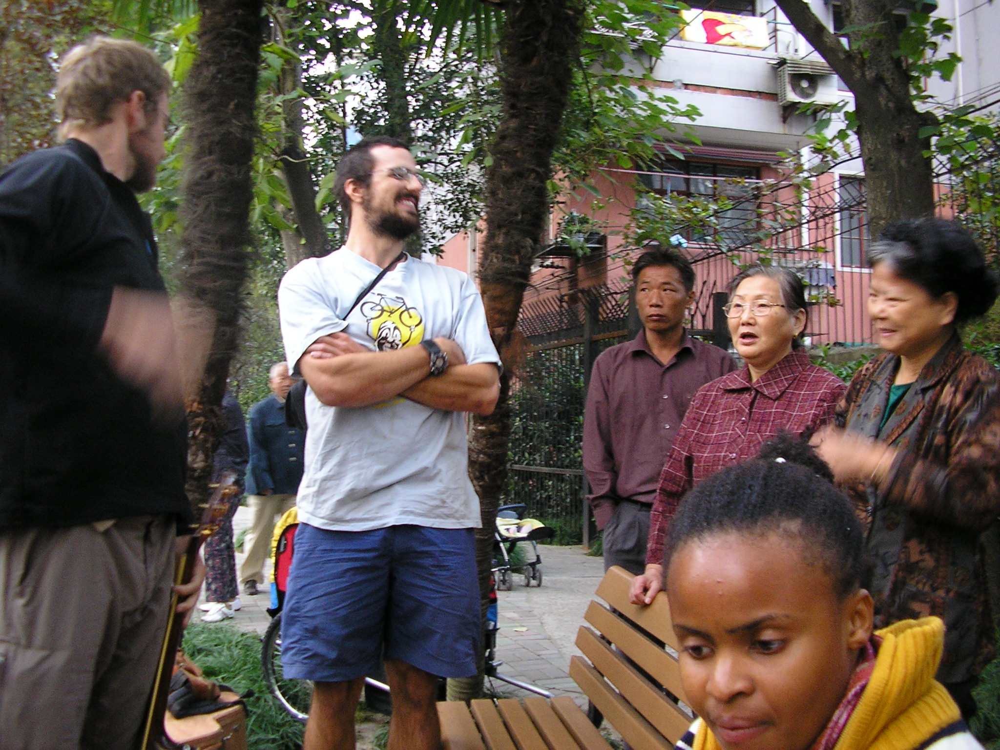 Shanghai = Talking with some locals in a small neighborhood park where we played some tunes for who ever stopped to listen