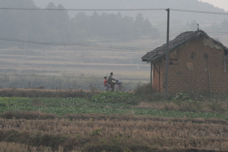 Picking up after school by bike - the standard mode of transit in China's countryside. A big contrast with China's big cities. 