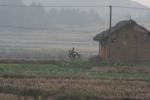 Picking up after school by bike - the standard mode of transit in China's countryside. A big contrast with China's big cities. 