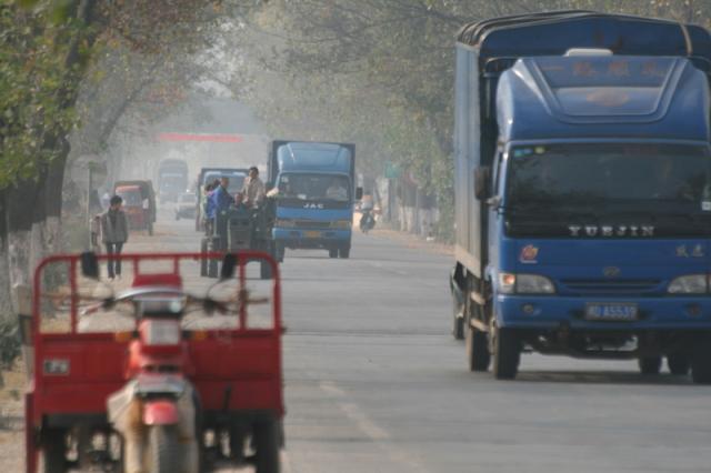 Busy traffic...The dreaded Chinese truck that enjoys freaquently blowing super loud air horns and blowing up dirt with exhaust p