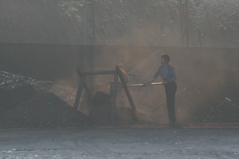 Southern Hunan. Shoveling coal. This area had many wholesale coal sellers as there were many nearby mines.