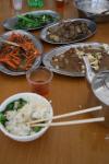 A typical fueled by rice lunch, from left center clockwise: Carrots & pork, Caixin (a Chinese green vegetable), Eggplant (Ho