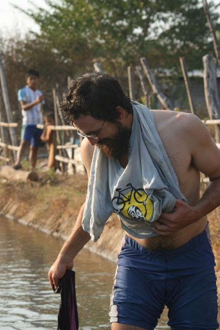 Lao - Jim in the irrigation ditch bathing or washing clothes?  Both at the same time?