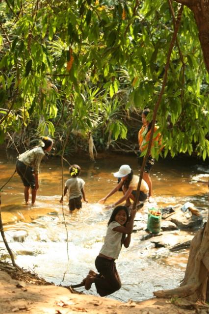 Cambodia - We invaded these children's swim hole one mid-day for our lunch and siesta stop. They didn't shy away from their usua