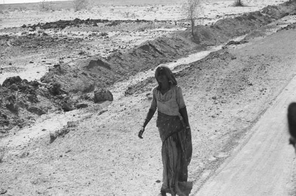 Village woman running some errands as our camels passed by.