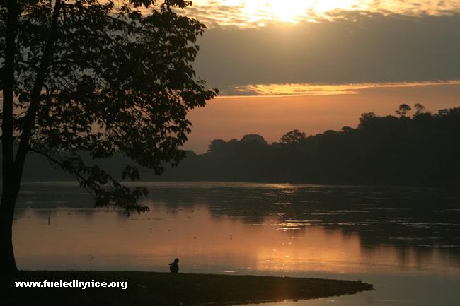 Cambodia - Angkor Wat moat with child at sunrise