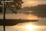 Cambodia - Angkor Wat moat with child at sunrise