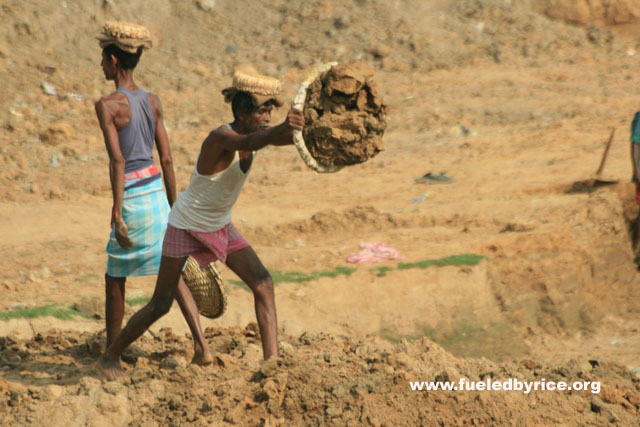 India, West Bengal - Laborers move dirt at a construction site. Like China, labor is cheaper than machinery.