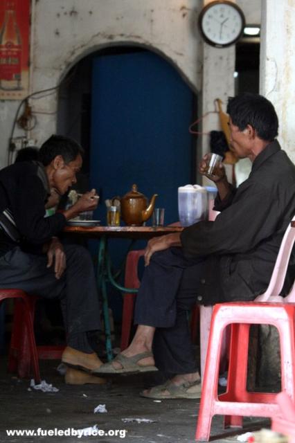 China - Guangdong Prov. - drinking tea at a typical hole in the wall restaurant.