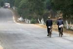 China, Guangxi prov - An older couple cycling to town. That so many Chinese still use bicycles as their main transport makes me 