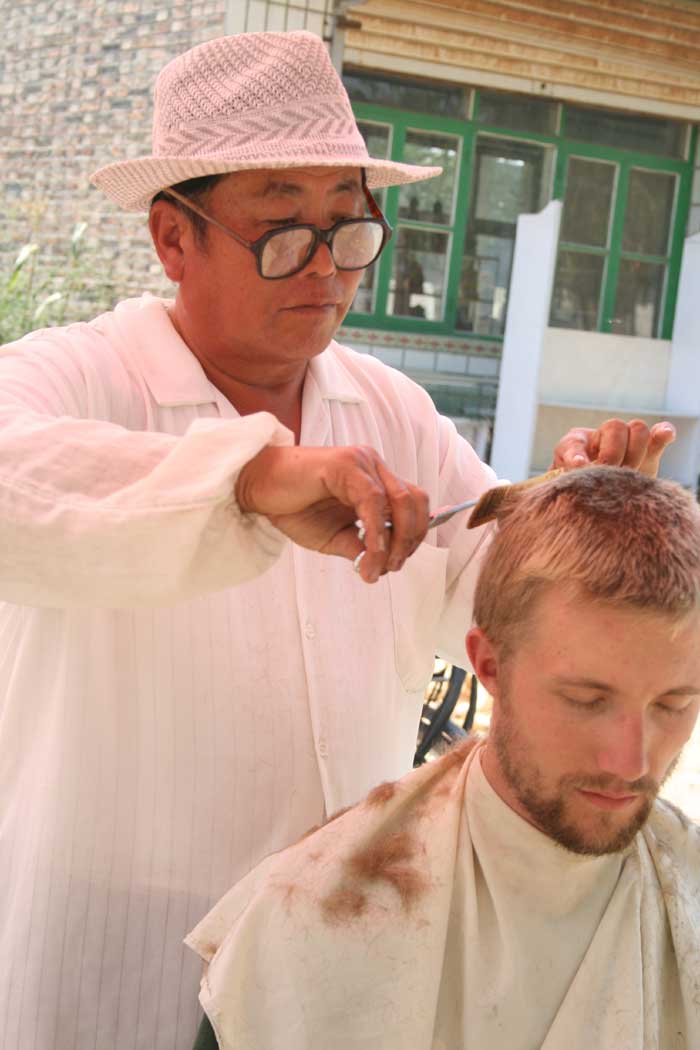 (Taken by Jim) Drew's haircut in a late morning market in Bei Liu Zhi village, Hebei province.