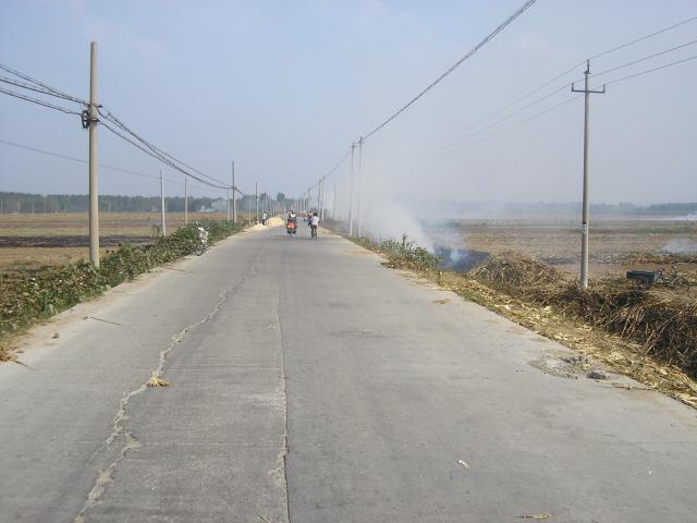 Smoke fills the air as corn staulks are burned after the harvest.