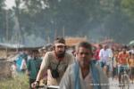 India, West Bengal - Jim riding away from a small market crowd that gathered around us when we stopped for a rest along a small