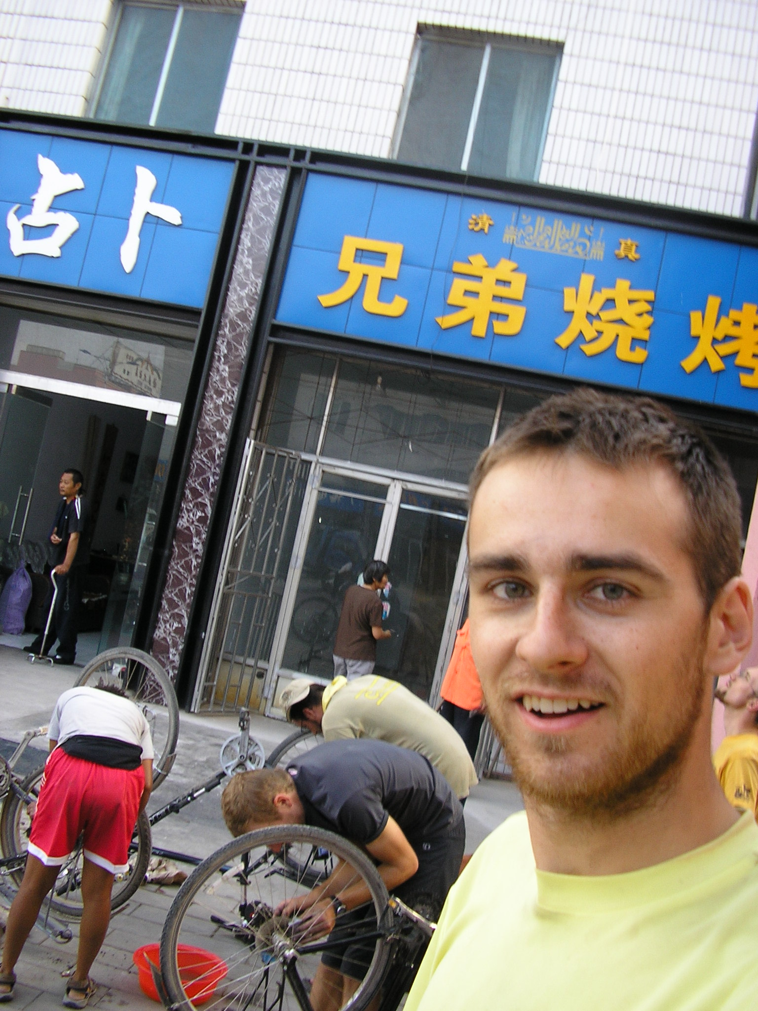 Peter...with some quality bike maintence happening in the background.  Chains scream for attention after riding in rain.  In Jia