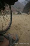 Nepal, Himalayan foothills, Sindhuli area backroad to Kathmandu - Peter's foot and wheel on the worst kind of rough road: sharp 