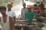 Nepal, west lowlands - Nepali cyclists walking hauling heavy loads of wood on their bikes...old but strong designed bikes