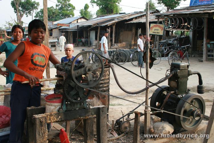 Nepal, west lowlands - Nepali Lemonaide Stand...Sugar Cane and salt. Running the sugar cane through the press. I don't know why 