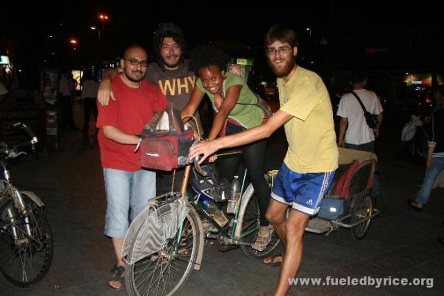 Türkiye, İstanbul - Nakia trying to fit on Peter's extremely tall bike, with Fatih and Mert