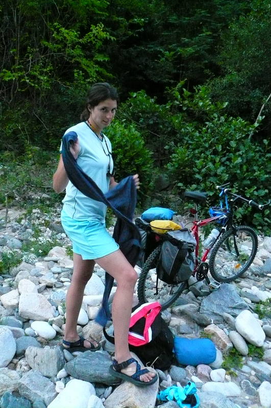 Autumn setting up her campsite. We had to lift the heavy bikes over a huge guard rail, apply brakes as we slid down a heavily wo