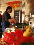 China - Cooking up lunch in a wooden fired wok, a common form of heat in the countryside. (Adam)