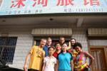 China, Jiangsu prov. Lianshui town - In front of our Luguan (cheap hotel) and the couple that runs it. They were very welcoming