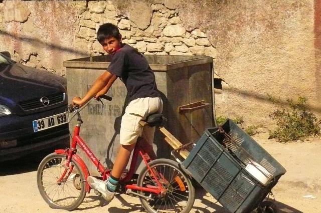 This boy is working on recycling - his cart was full of bottles.