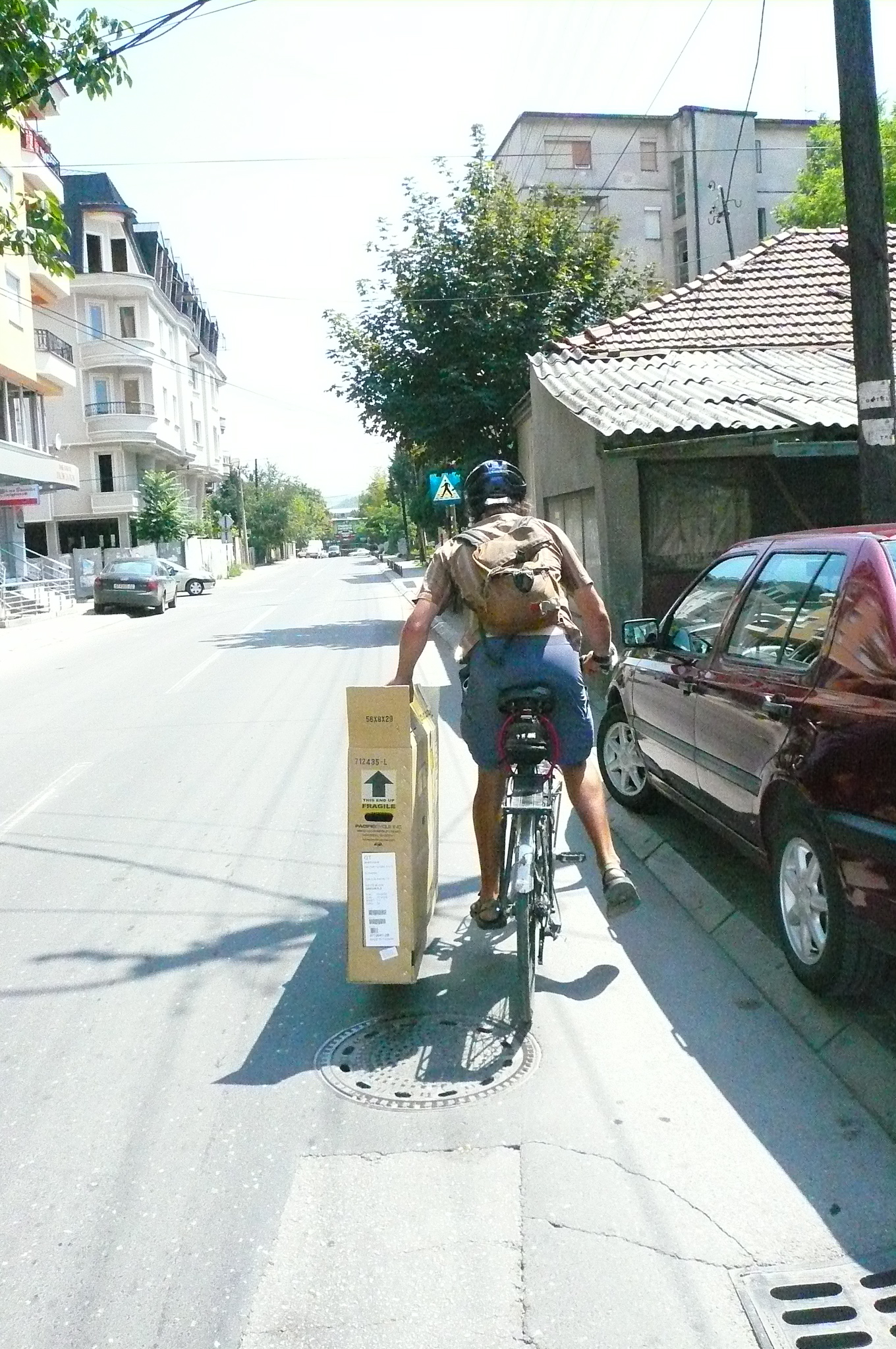 Jim and I spent about 4 hours tracking down a box for me to pack my new touring bike in to transport home. Here he is carrying i