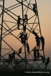 Nepal, east lowlands, Jamunibas village [homestay] - children play on high-voltage powerlines next to their village's soccer fie