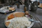 India, Rajistan, Jaipur - 15 Ruppees (US$0.45), all you can eat Rice Dal - aka Rice, Lentals, Veg curry. Sure, sometimes to get 