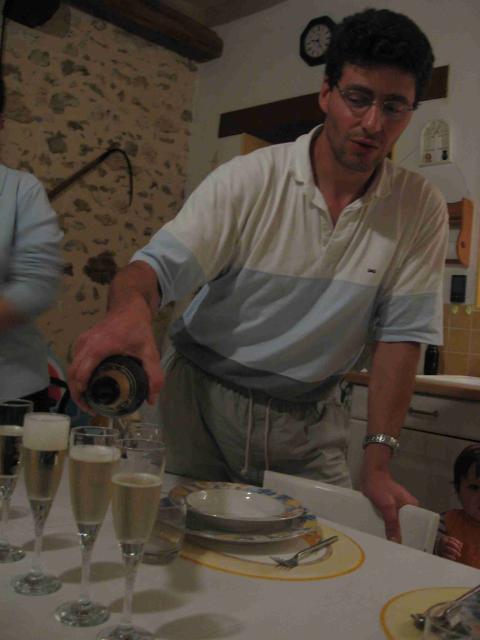 Laurent pours champagne