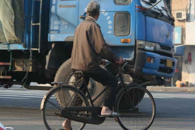 Oct 10 2007 - Wuxi town, morning. Truck versus bike.  