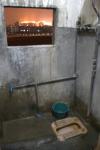 Nov 26 2007 - 50km south of Guangzhou. Typical communal bathroom and "shower." No hot water, another sign that we're m