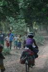 Lao - Nakia biking through a village (Peter)