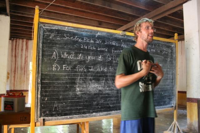 Cambodia - Drew teaching his part of our fueled by rice spontaneous English lesson in a Buddhist Monastery school.