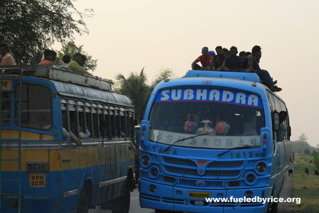 India, West Bengal - Indians often ride on the tops of overcrowded buses