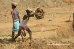 India, West Bengal - Laborers move dirt at a construction site. Like China, labor is cheaper than machinery.