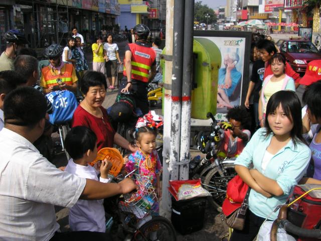 China - An inquisitive crowd in Dezhou City gathers as we prepare to leave.
