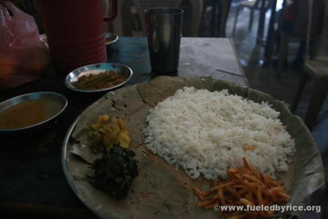 India, West Bengal - A typical West Bengali lunch served on environmentally-friendly leaf plates. Rice, spiced potato slices, po