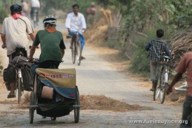 India, West Bengal - Jim and Drew (with Bandwagon) making their way on a small back road