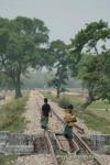 India, West Bengal - Kids walking along a traintrack