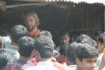 India, West Bengal - Andrew addressing another Indian crowd, mostly men - typical in India, we see few women in the towns.