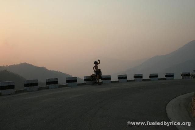 Nepal, Himalayan foothills, road to Sindhuligati - Peter stopping for a much needed water break at dusk. Our first major Himalay