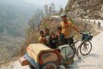 Nepal, Himalayan foothills, Sindhuli area - a few local kids helped Drew by pushing the Bandwagon.