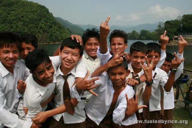 Nepal, Pokhara - School boys. Someone taught them the bird. We noticed Nepali people seemed more Western than Indians, seemingly