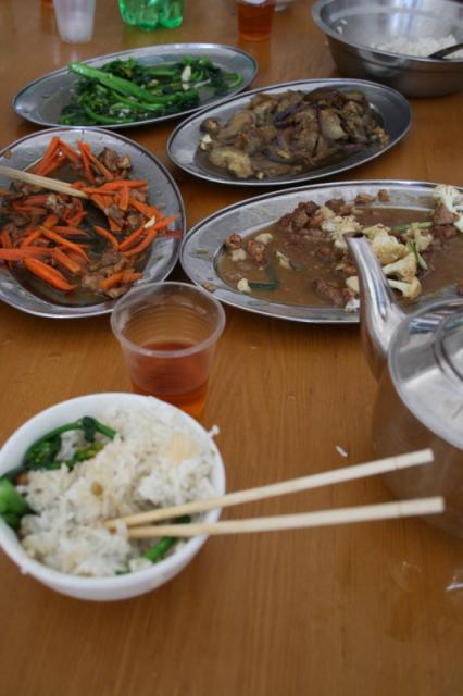 China - A typical fueled by rice lunch, from left center clockwise: Carrots & pork, Caixin (a Chinese green vegetable), Eggp