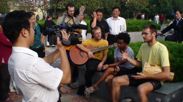 China, Shu Yang Town - FBR performs in a park with local TV news coverage