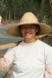 China, Guangdong - An enthusiastic farmer harvesting sugar cane, came up to chat and invite us down to the field (Peter)